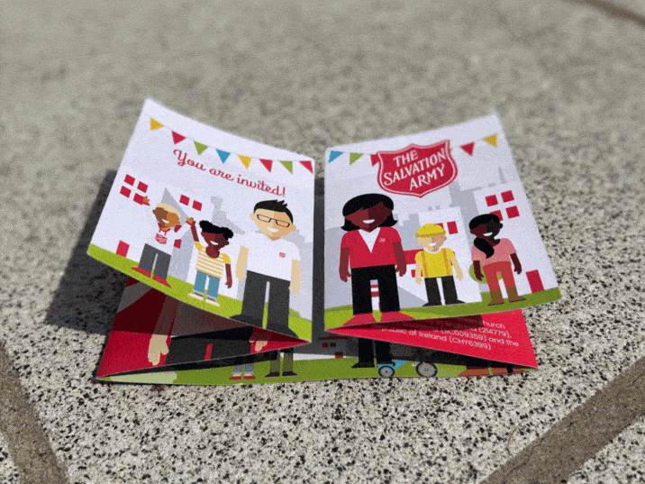 a short, looping GIF of a fold-out leaflet, featuring colourful bunting and cartoon characters