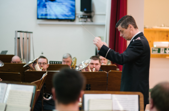 A Salvation Army brass band leader conducting