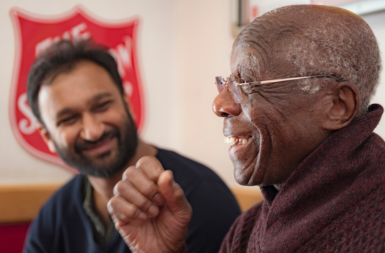 An older and younger man talking at The Salvation Army