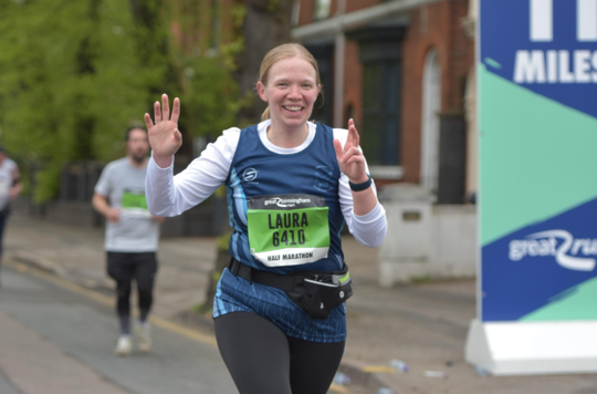 Laura-Jayne Kingscott running in a half marathon and smiling