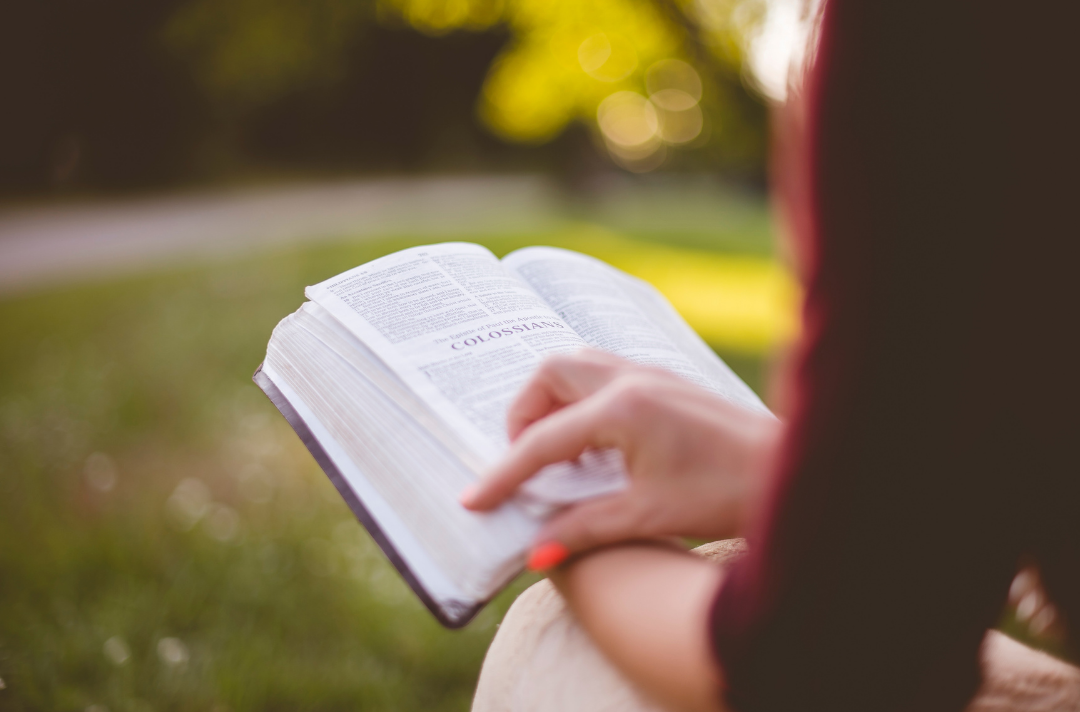 A stock image of someone reading the Bible.
