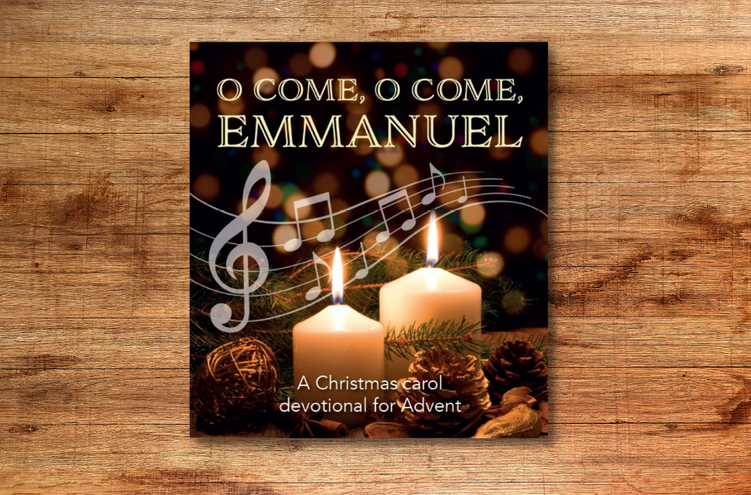 A photo of the O Come, O Come, Emmanuel book cover, featuring two lit white candles and a graphic of musical notes