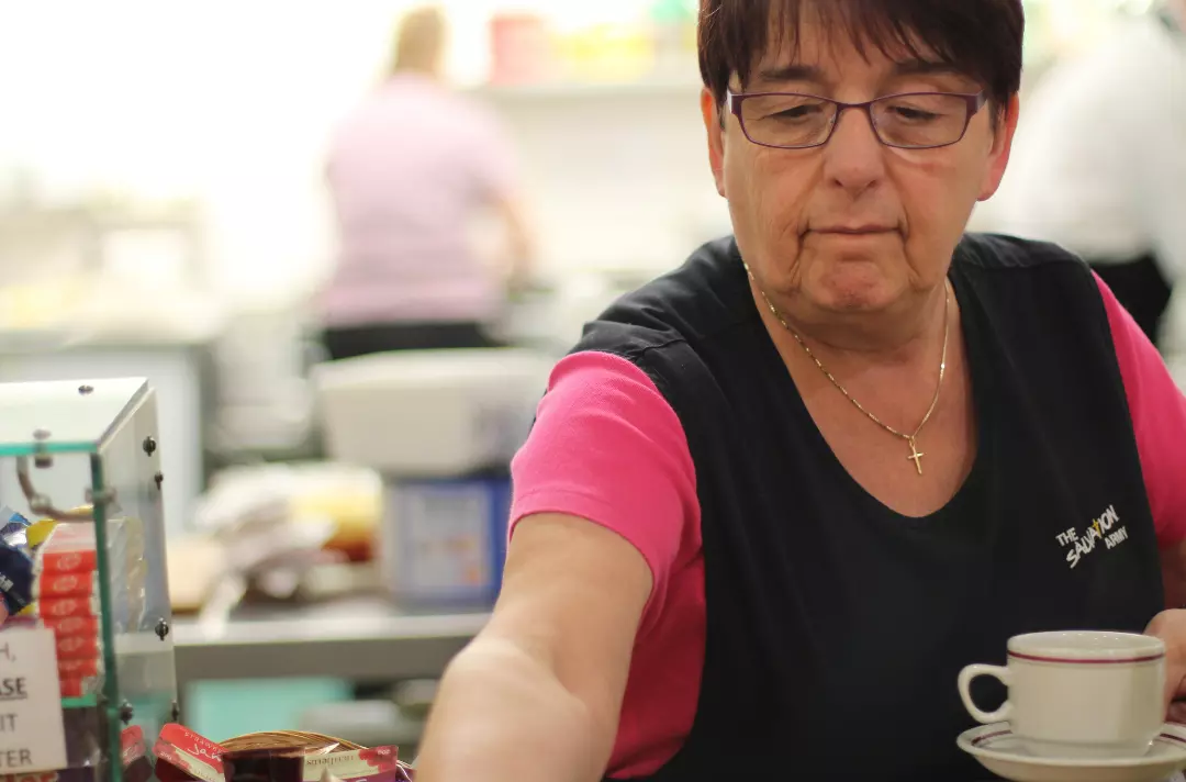 Salvationist serving a coffee