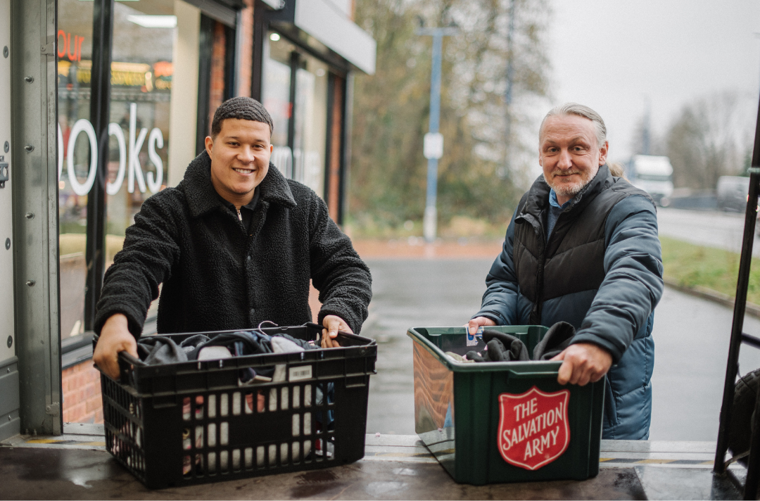 Salvation Army volunteers lifting donations