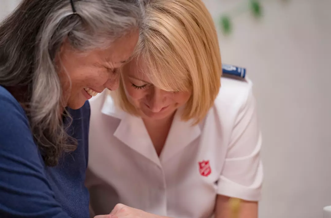 A Salvationist speaking with an older woman