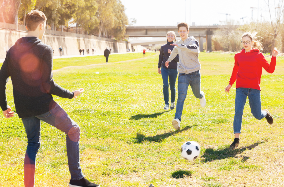 Teenagers playing football