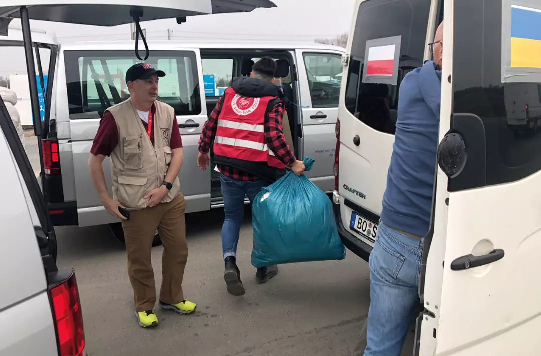 Captain Matthew Beatty helps load up supplies into vans