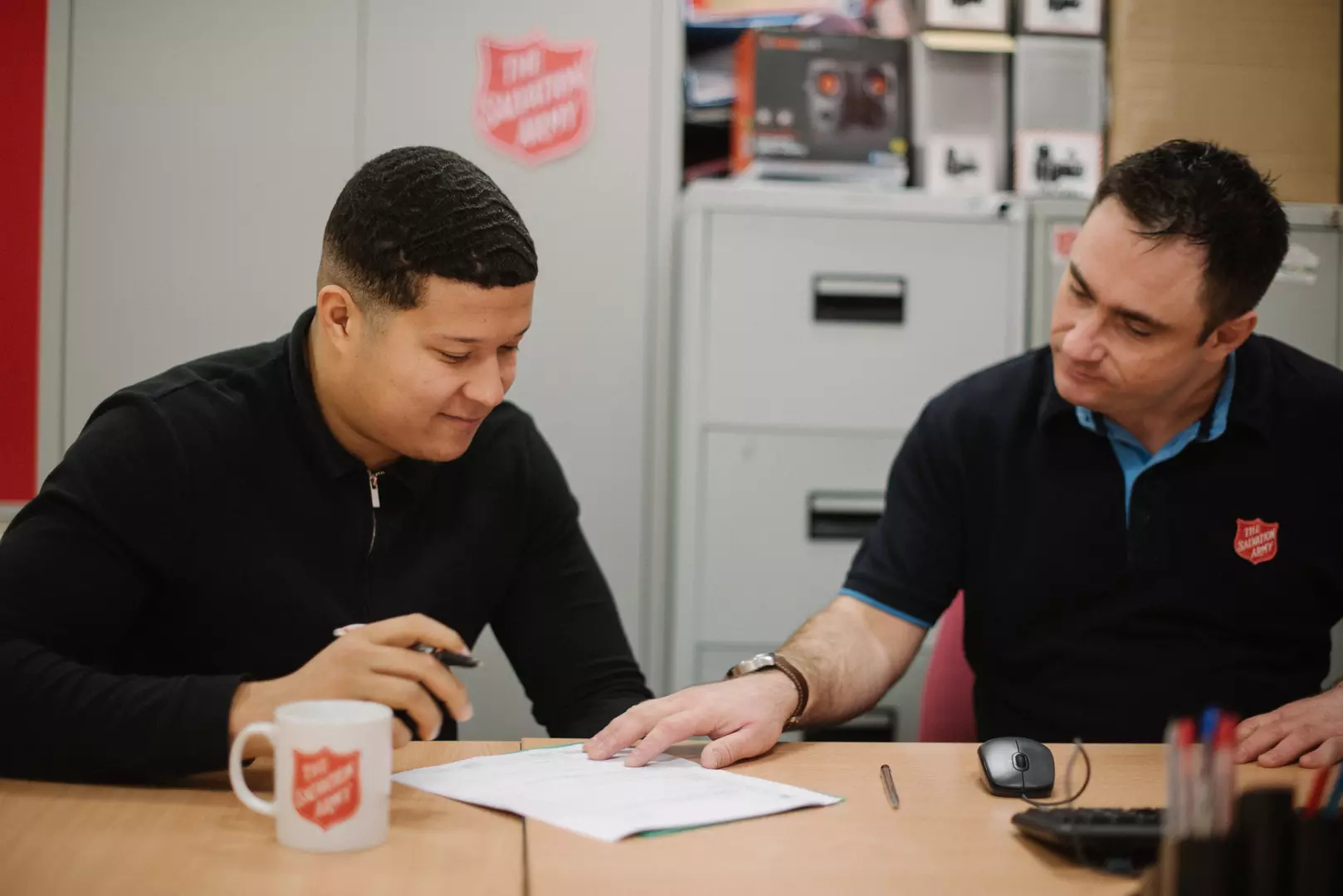 Someone receiving support with paperwork from The Salvation Army