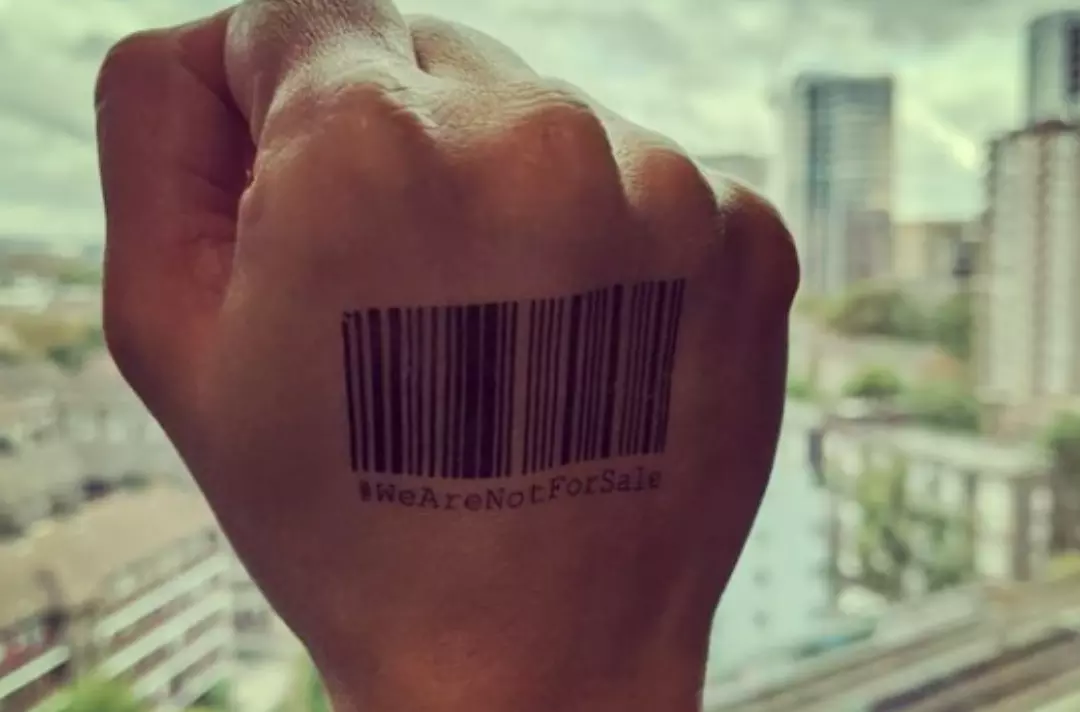 Someone wearing a #WeAreNotForSale temporary tattoo