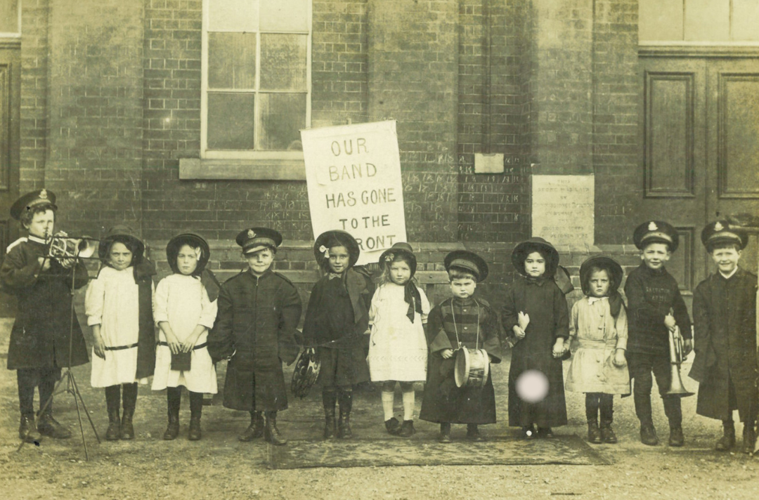 An old back and white photo of children wearing Salvation Army uniform
