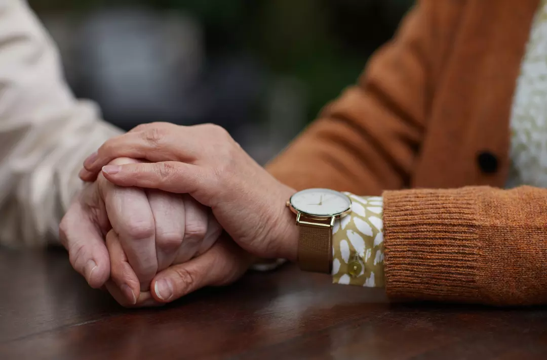 Two people holding hands