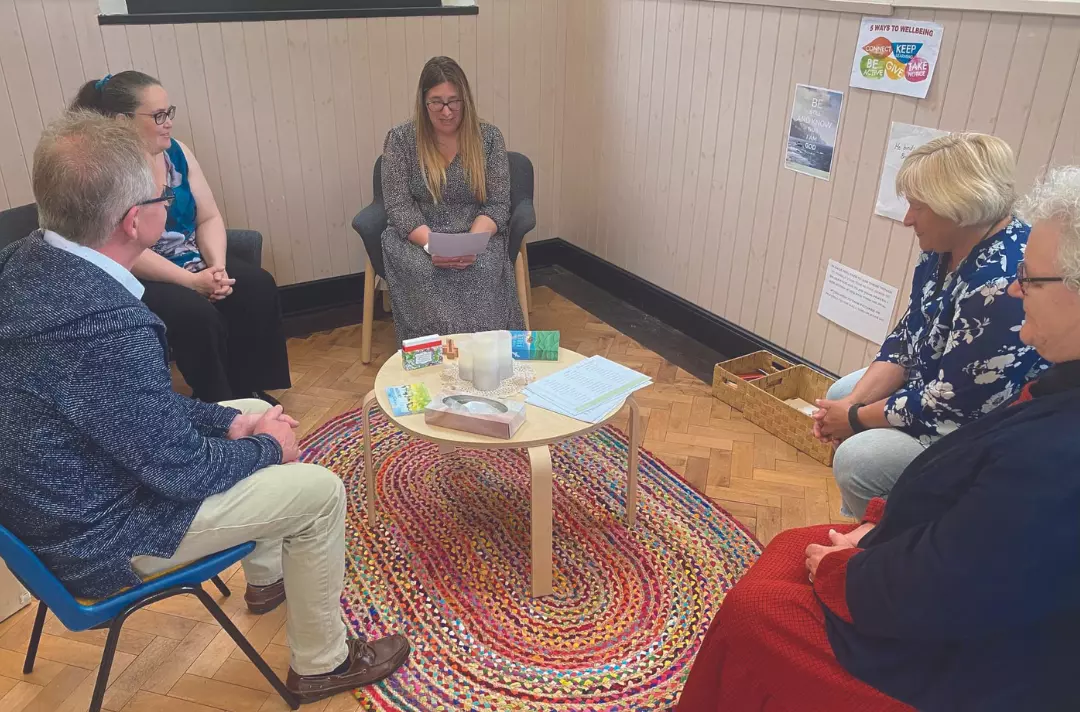 People sitting in a circle sharing prayer
