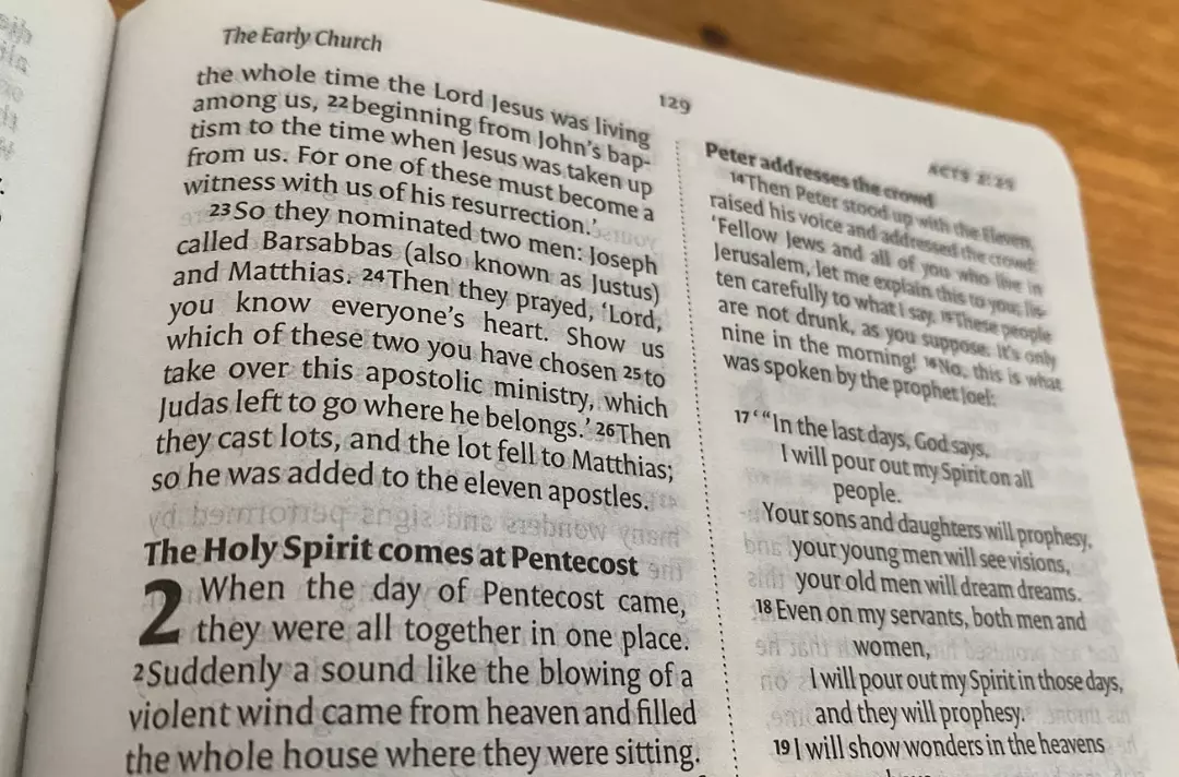 A photo of the Bible open at Acts 2: The Holy Spirit comes at Pentecost