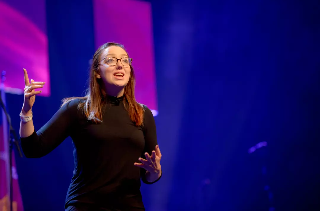 Someone performing a dramatic reading on stage