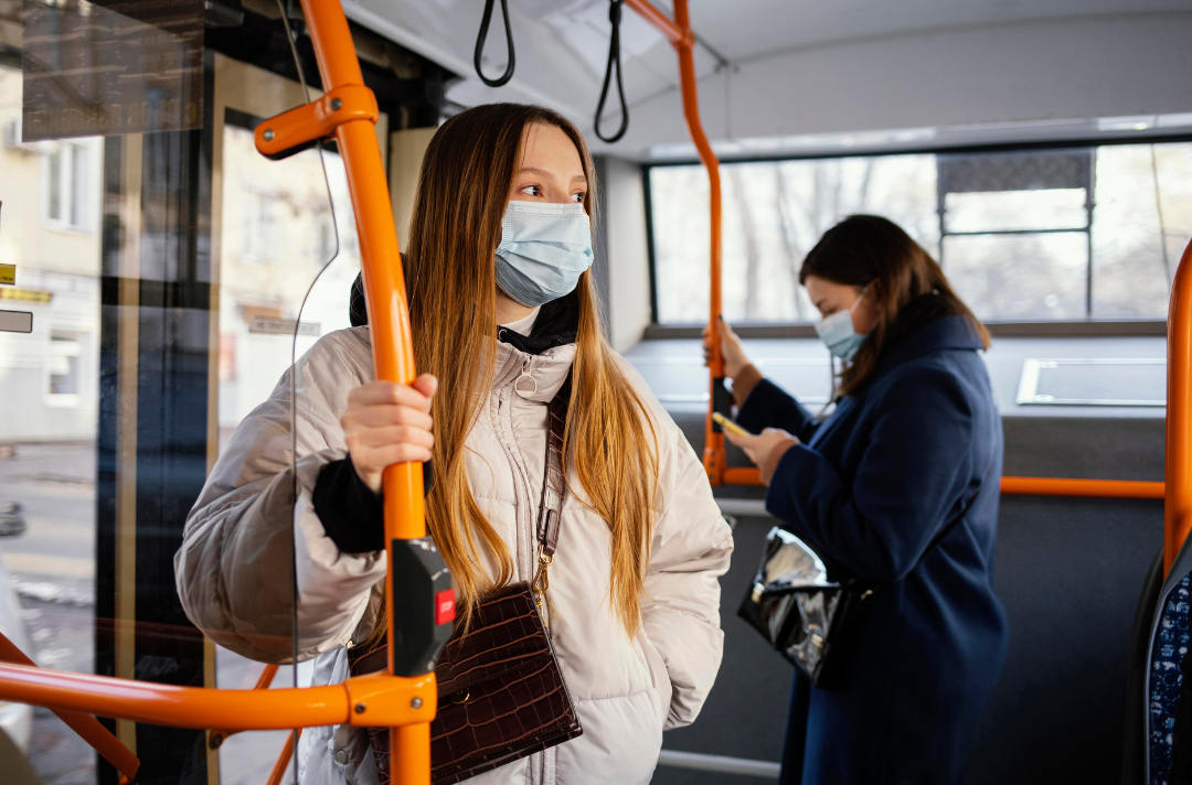 People on a bus wearing face masks