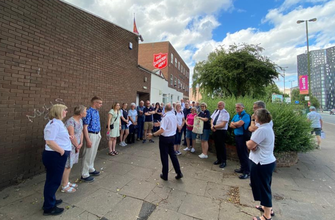A group of people standing outside Birmingham Citadel Salvation Army 