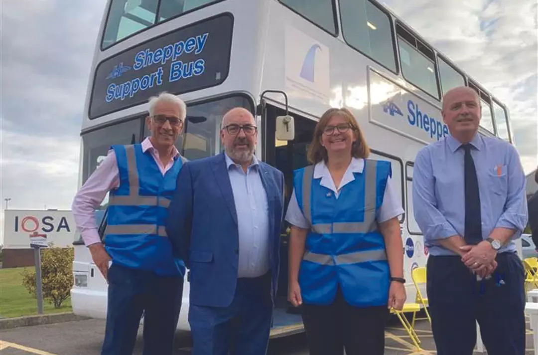People standing in front of the Sheppey Support Bus