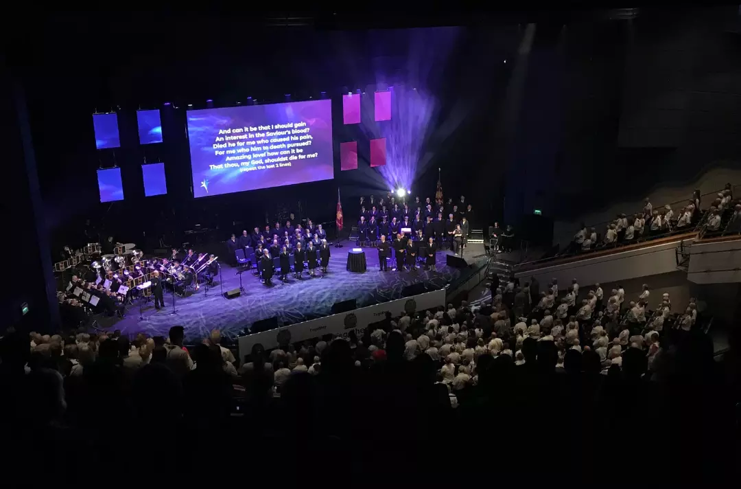 A packed auditorium and stage