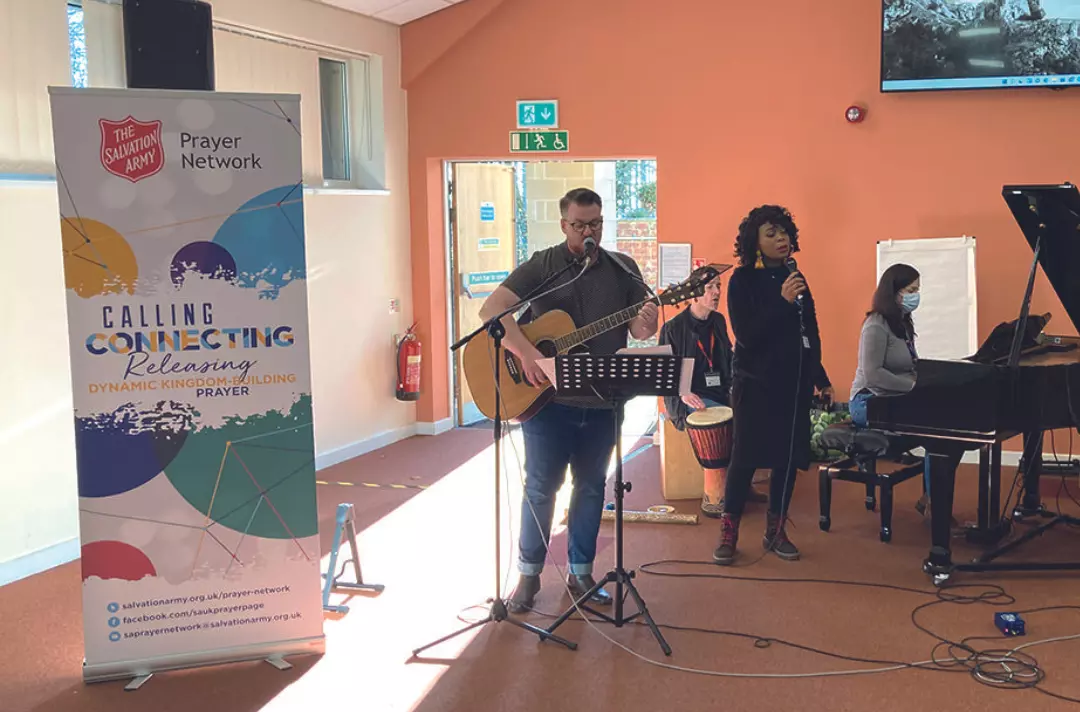 A worship band with guitars, drums, piano and singers