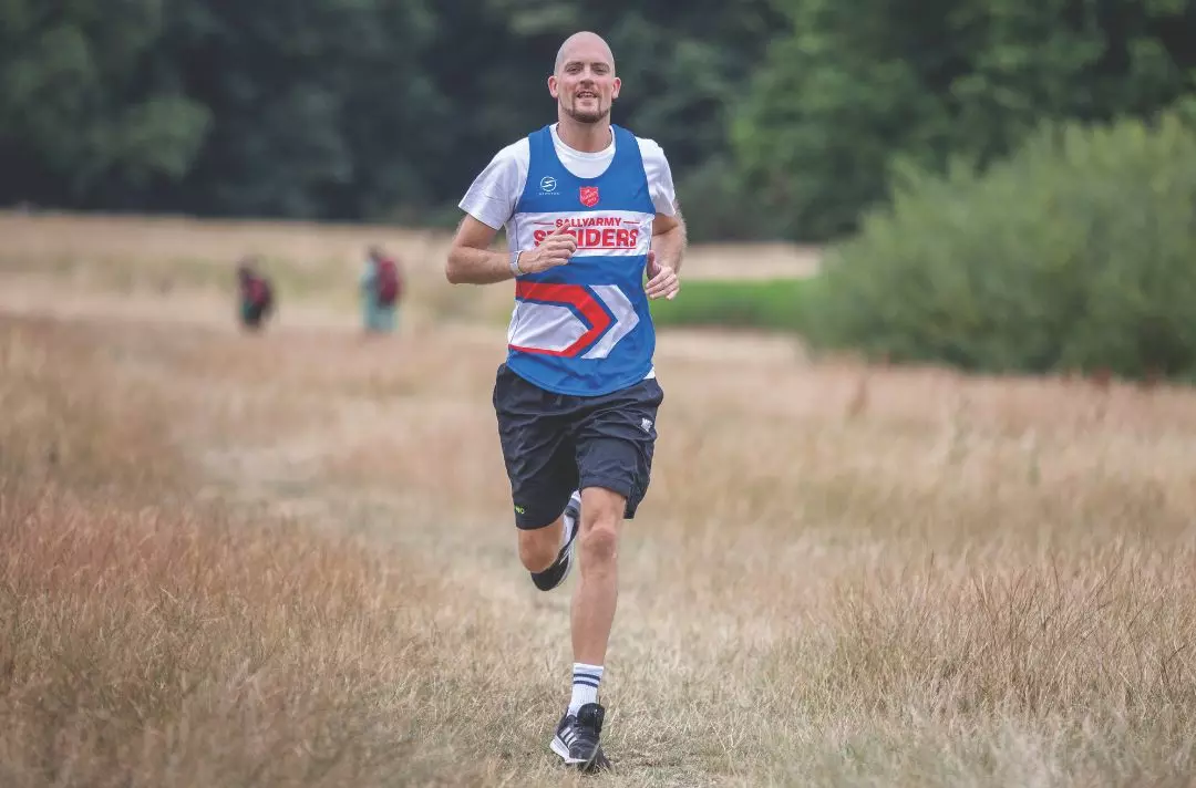 Glyn Wise running in a Salvation Army running top