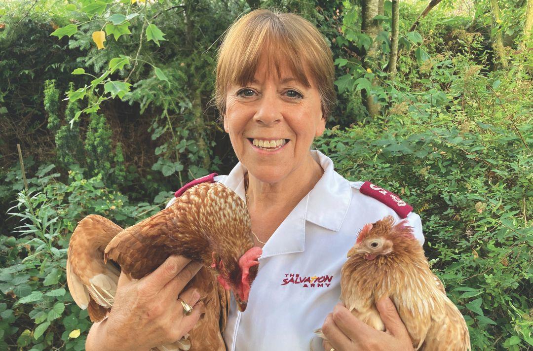 Vivienne Prescott wearing Salvation Army uniform and holding two chickens