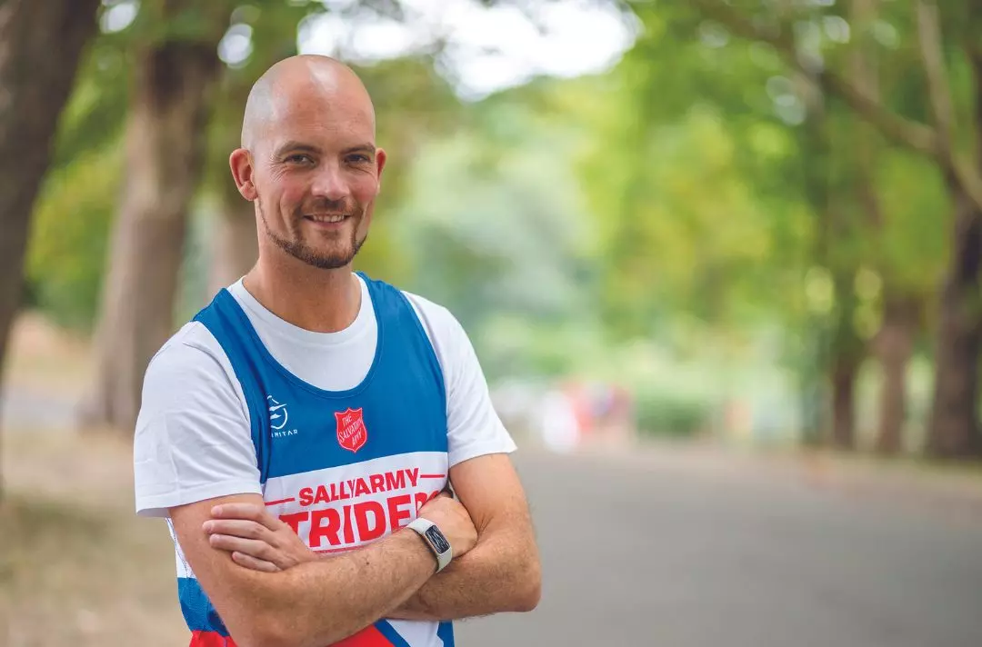 Glyn Wise with his arms crossed wearing a Salvation Army running top
