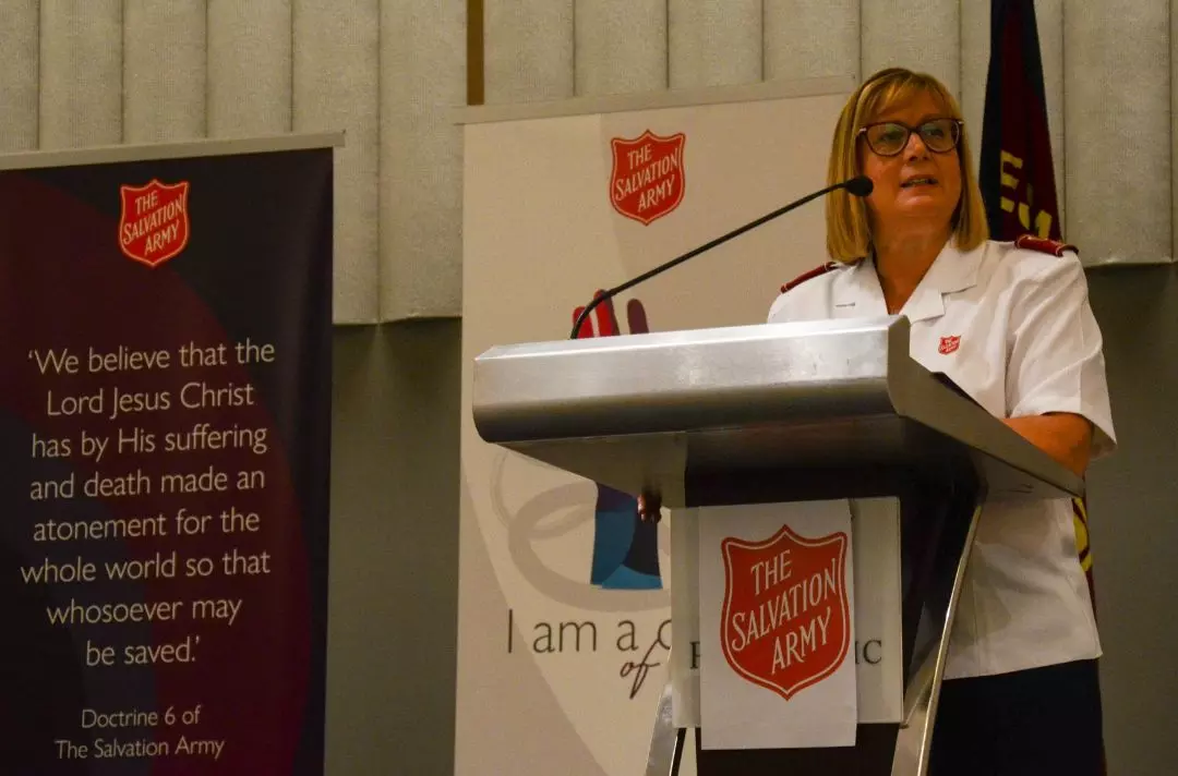 Julie Forrest speaking at a microphone
