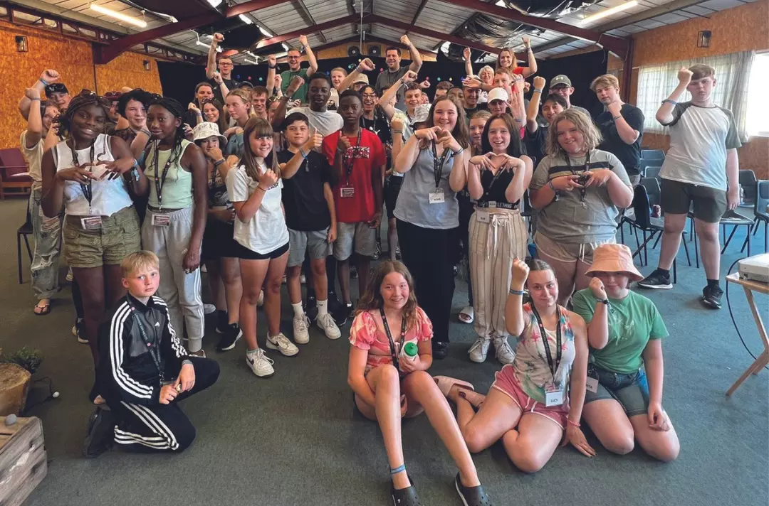 A large group of teenagers and adults smiling