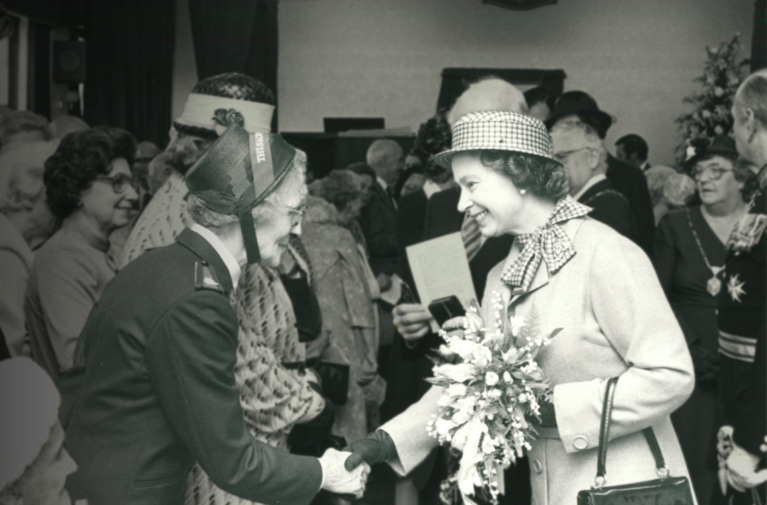Queen Elizabeth II shakes hands with a Salvationist