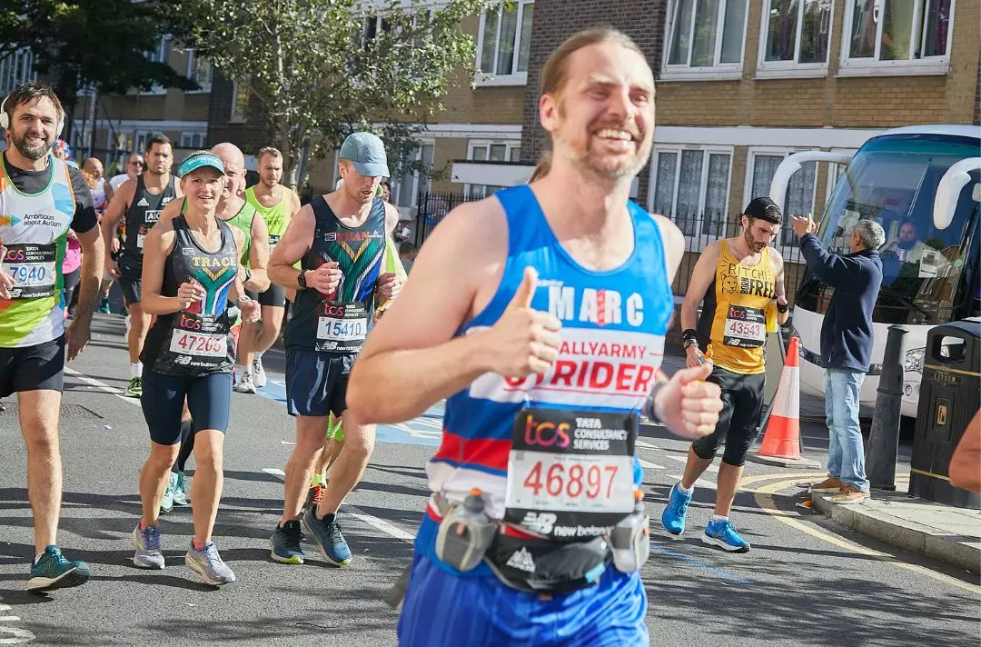 Someone running in a race wearing a Salvation Army running vest