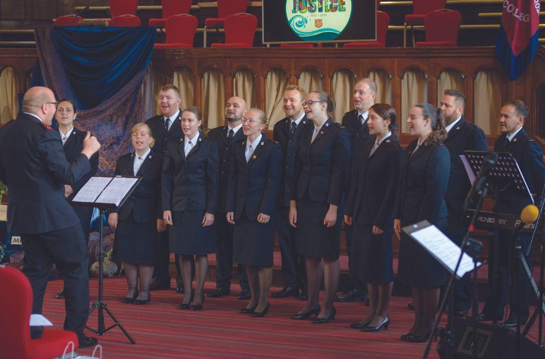 A choir singing with people wearing Salvation Army uniform