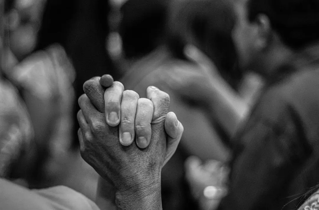 Two people holding hands