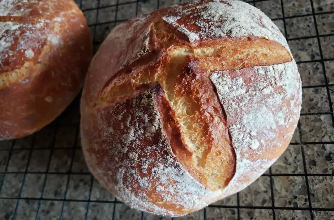A sourdough loaf with a cross scored on top