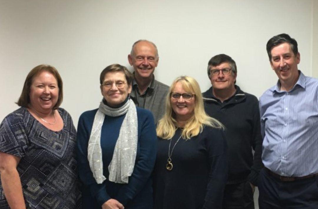A photo of six people of standing in a group - the Douglas debt advice team