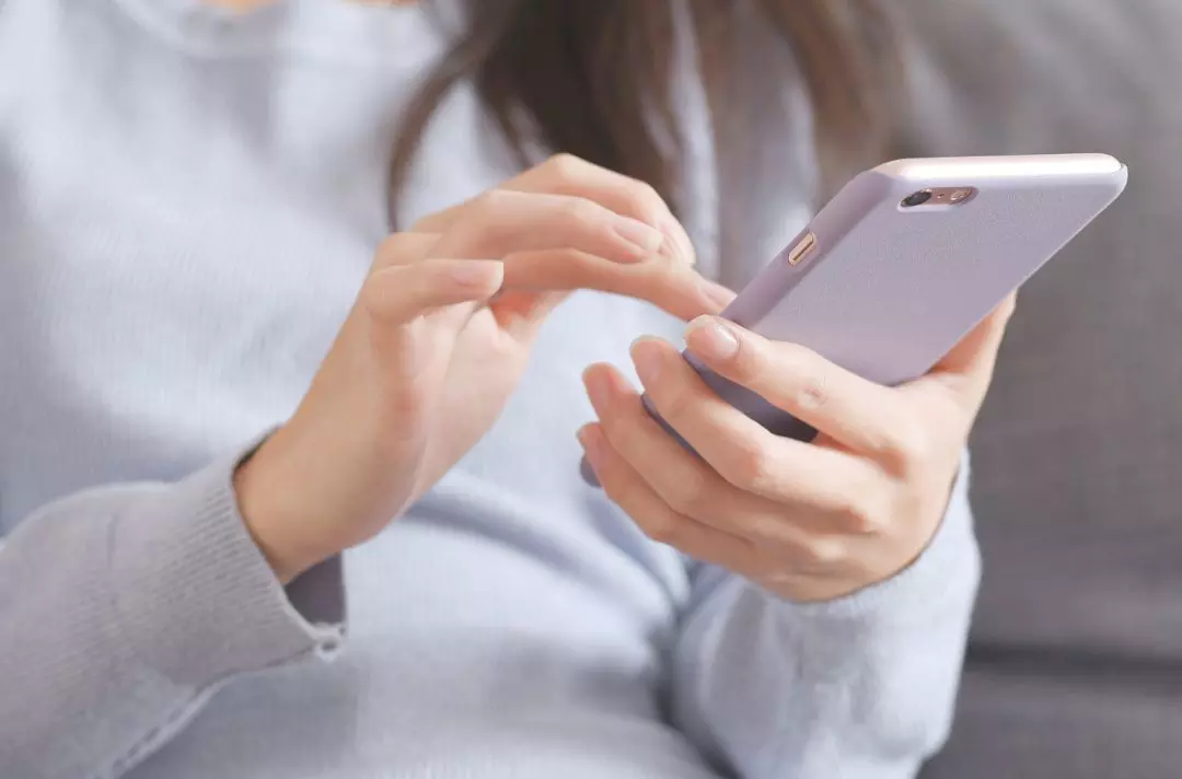 A photo of someone scrolling on their mobile phone
