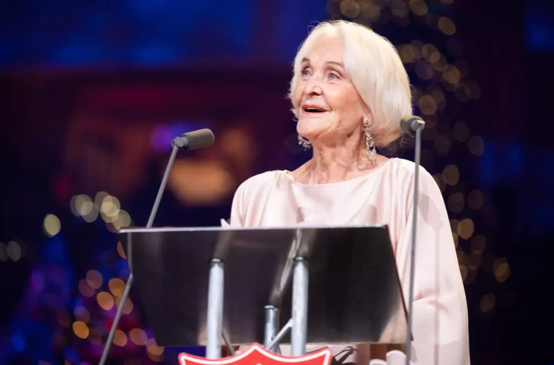 A photo of Sheila Hancock reading the Bible on the stage at the Royal Albert Hall