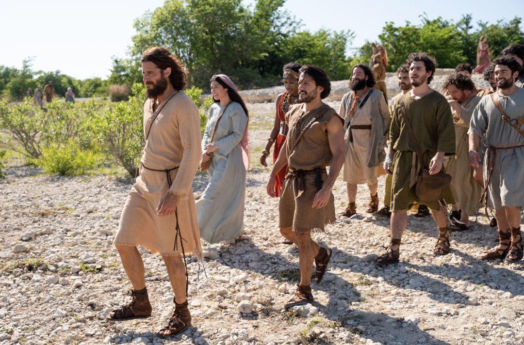 A photo from the TV series of Jesus walking with his disciples