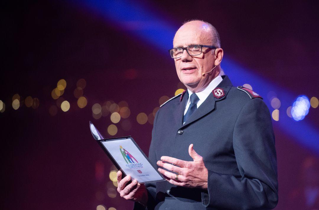 A photo of Commissioner Anthony Cotterill sharing a Christmas message on stage at the Royal Albert Hall