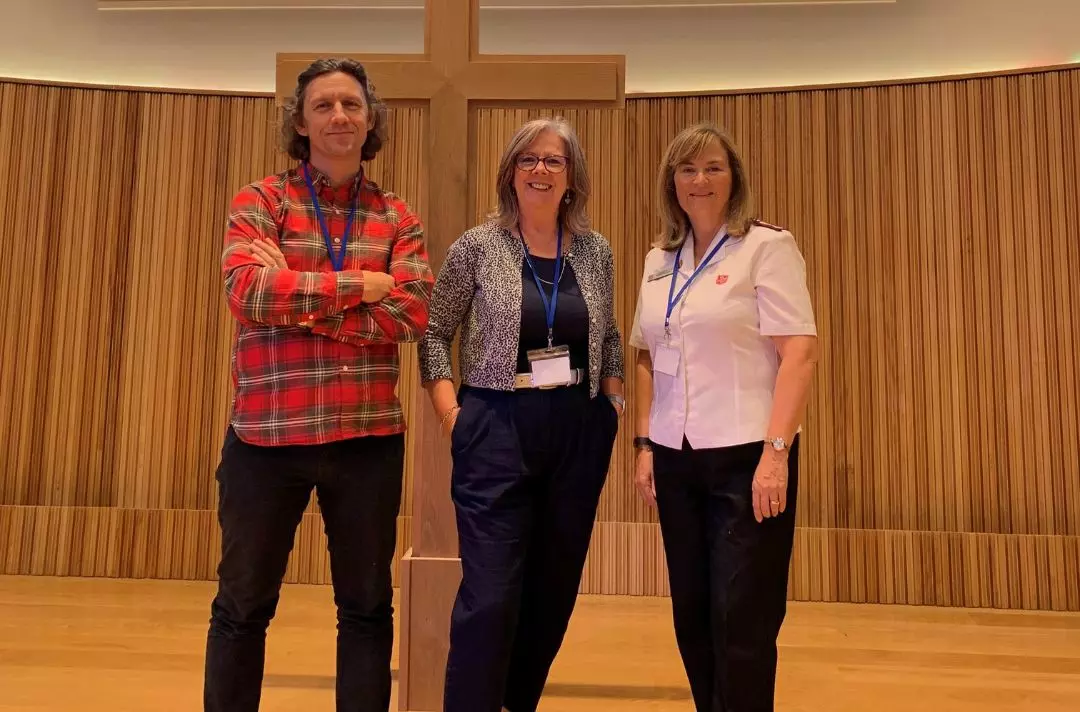 A photo of Paula Haylett posing for a photo with two other attendees of the summit