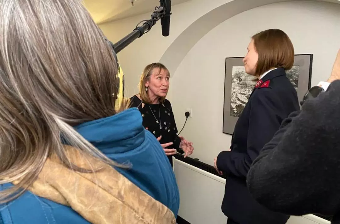 A photo of Tilly Vosburgh being interviewed in her dressing room back stage by Captain Jo Moir