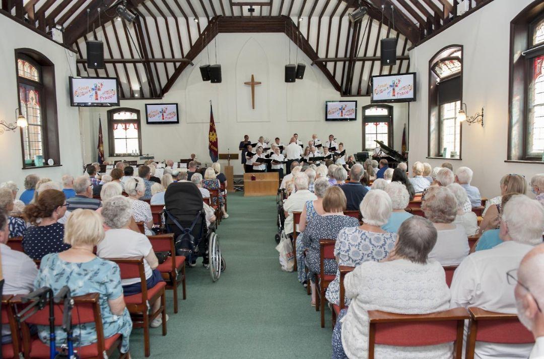 A Songs of Praise meeting inside Felixstowe Salvation Army. The full congregation listens to the songsters sing