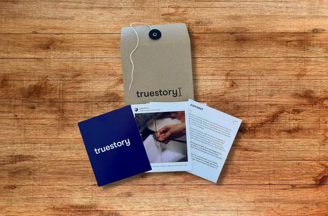 The photo of the True Story resource: a brown envelope with postcards with photos and text on them