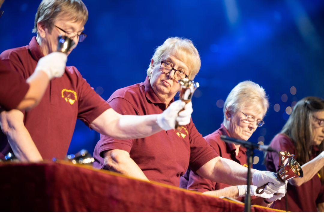 A photo of Broxbourne Handbell Ringers performing on stage at the Royal Albert Hall