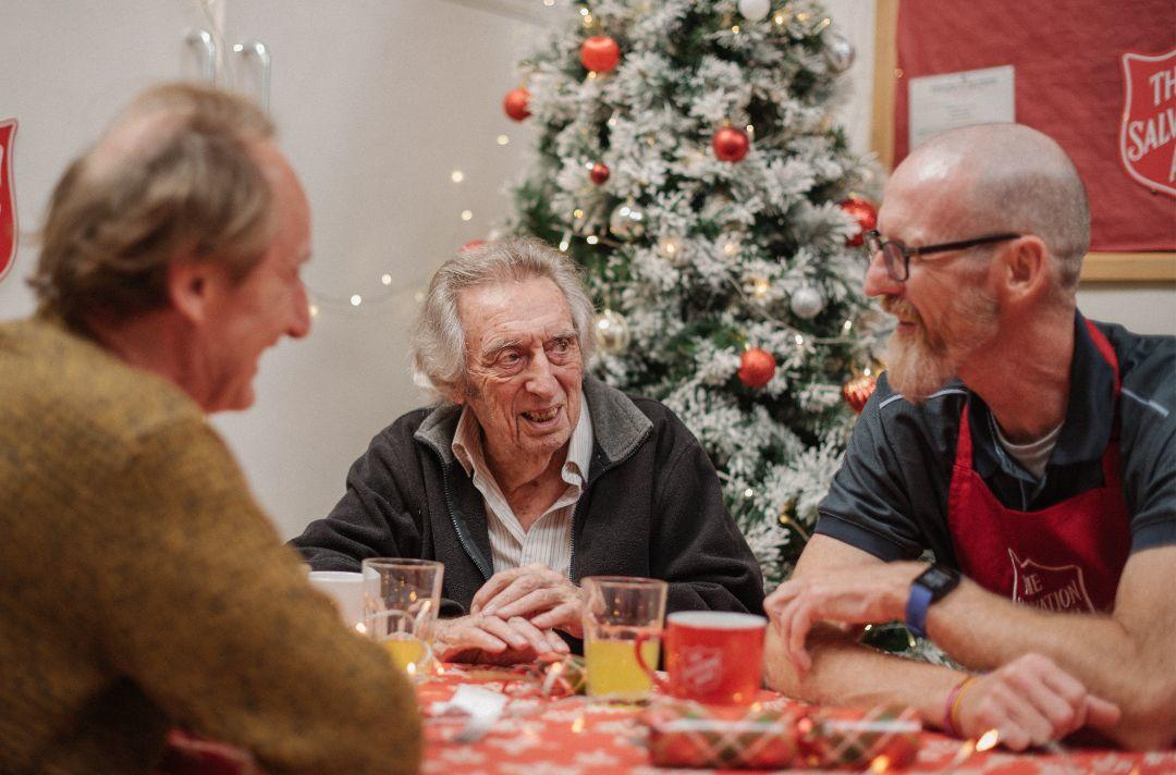 A photo of three people having Christmas lunch at The Salvation Army