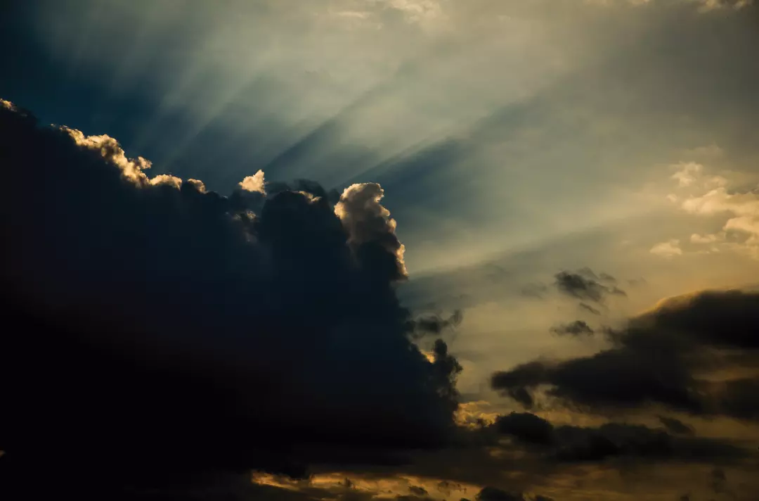 Photo shows light breaking through dark clouds