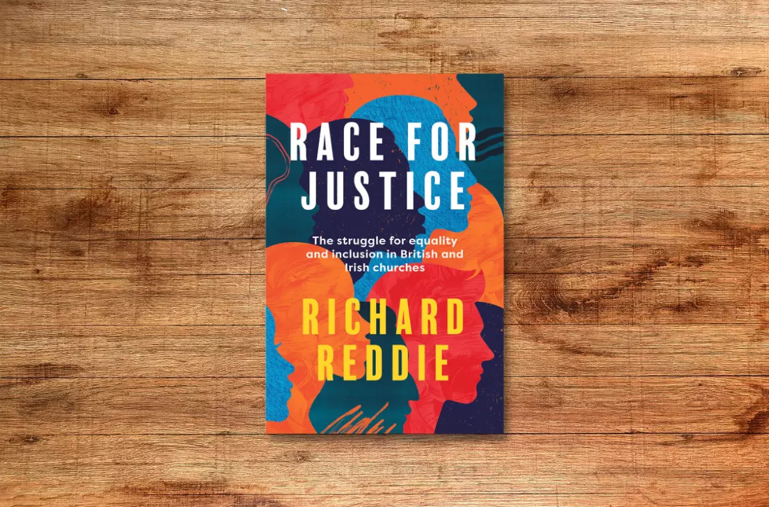 Image shows the front cover of the book Race for Justice against a wooden background.