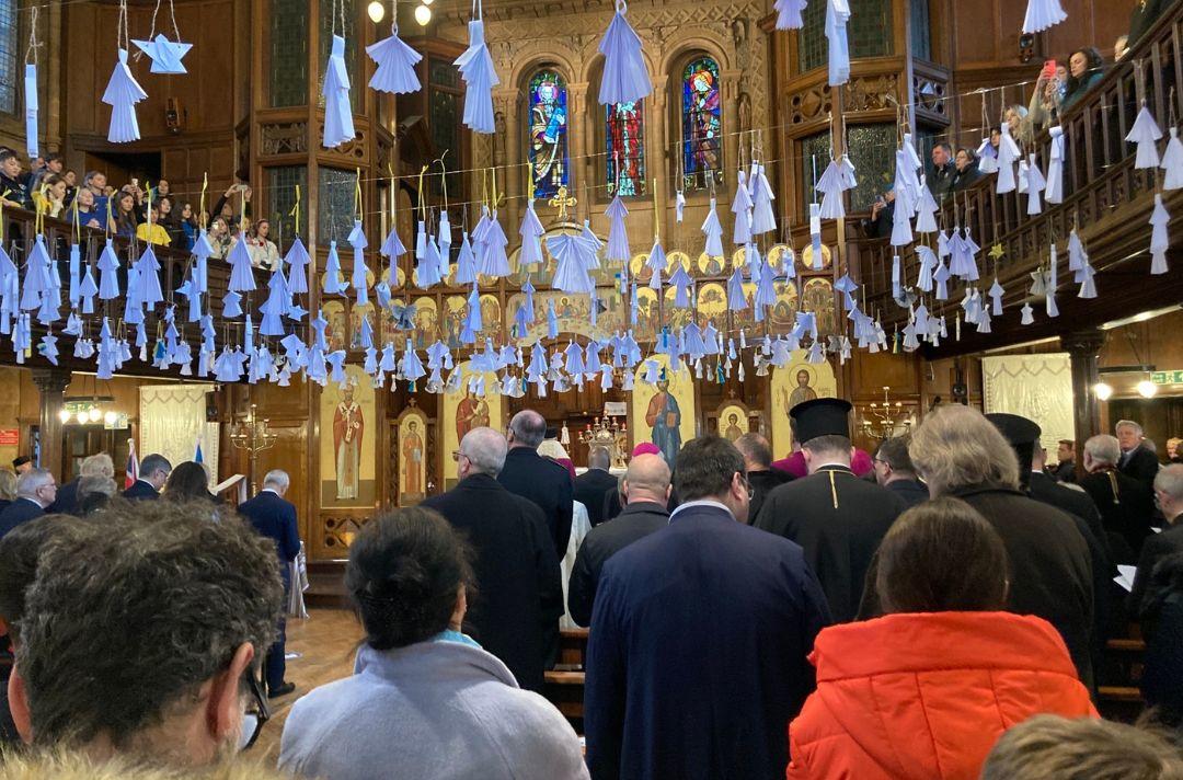 A photo of paper doves hanging from inside the Ukrainian Catholic Cathedral in London
