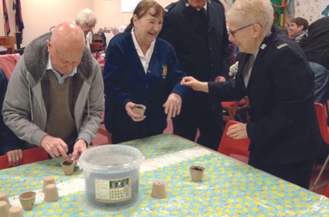 A photo of members of Redruth Salvation Army sowing seeds in their corps hall