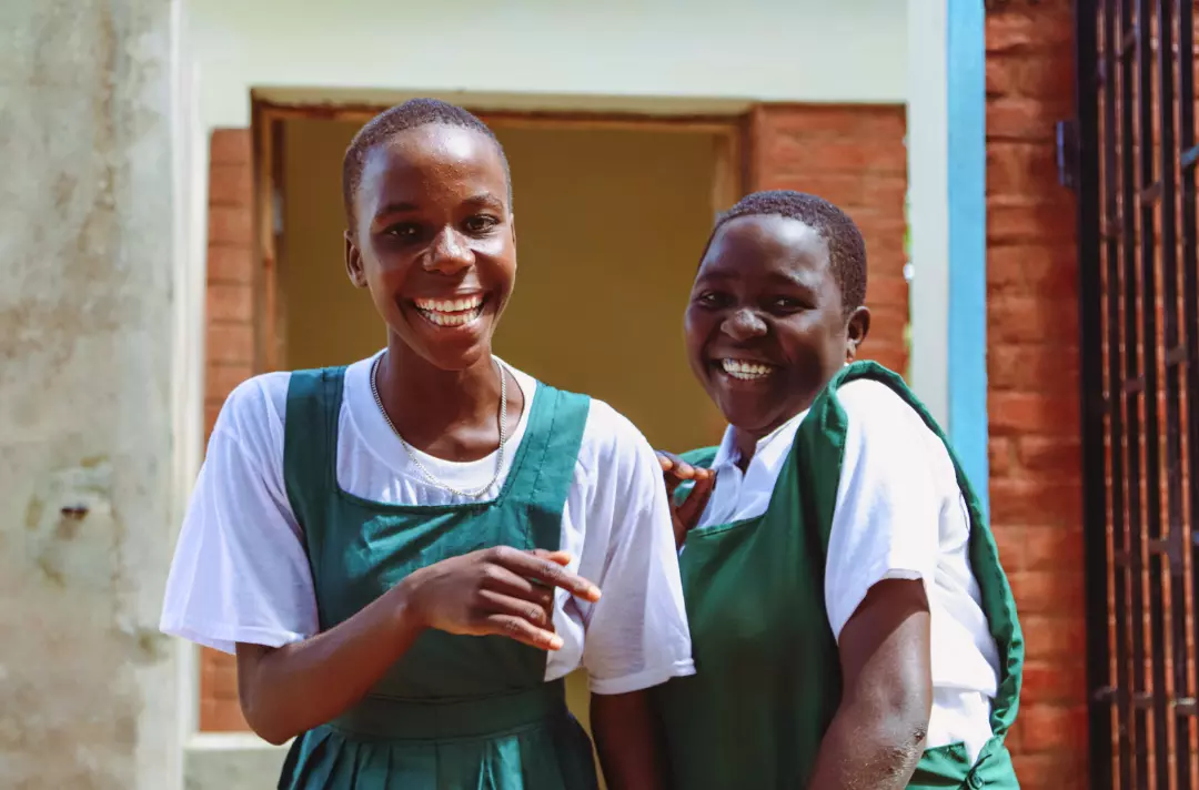 Photo shows two young people who are smiling and laughing.