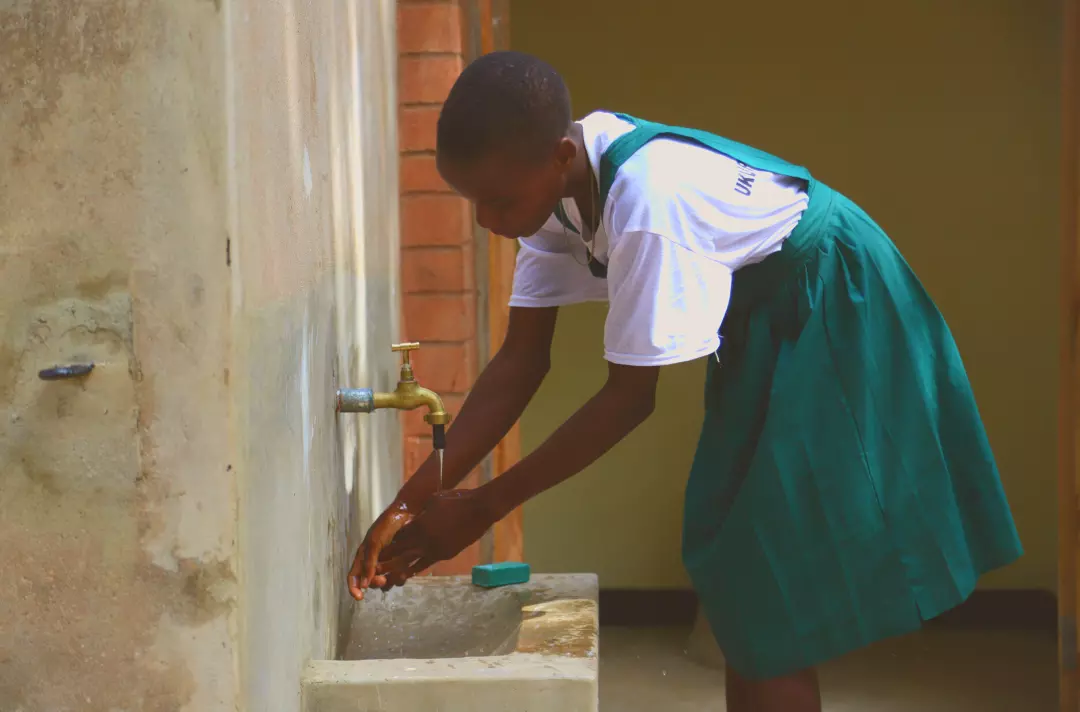 Photo shows Mary washing her hands.